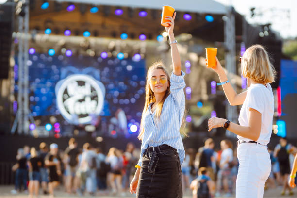 istock Two young woman drinking beer and having fun at Beach party together. 1491893016