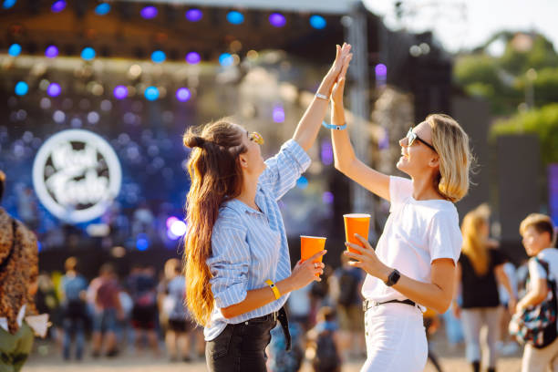 istock Two young woman drinking beer and having fun at Beach party together. 1491893018