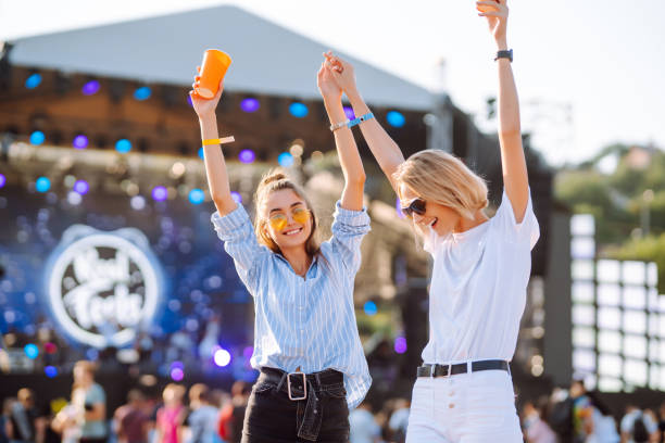 istock Two young woman drinking beer and having fun at Beach party together. 1491893025