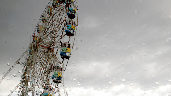 A Ferris wheel is an amusement ride consisting of a rotating upright wheel with multiple passenger-carrying components attached to the rim in such a way that as the wheel turns, they are kept upright, usually by gravity.