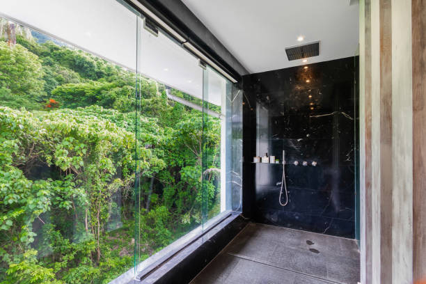 istock Luxury bathroom black with marble wall  has a large glass window overlooking the trees and nature, Black bathroom decorated with a calm and relaxing look. suitable for relaxation, There are large windows natural light shining into the room. 1491894624