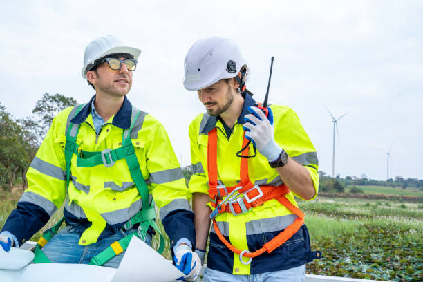 istock Engineer man looking and checking wind turbines at field. 1491894756