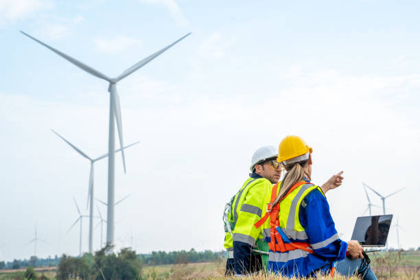 istock Engineers planning discuss project and working in wind turbine farm. 1491894893