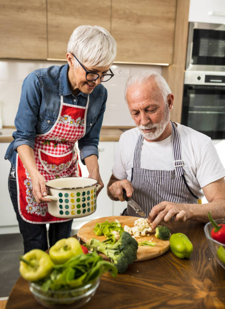 istock Senior couple preparing vegetable soup at home 1491913931