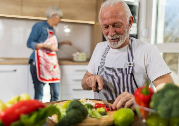 istock Senior couple preparing vegetable soup at home 1491915032