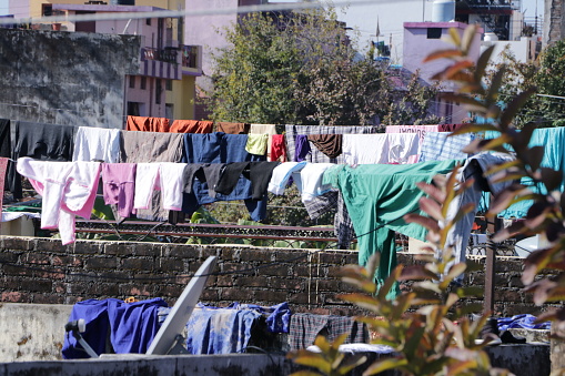After many days of rain, clothes drying in the sun when the weather opens and the sun rises, this is the view from a terrace in Dehradun. Uttarakhand. India.