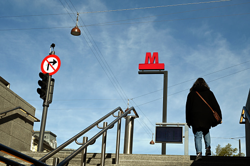Copenhagen, Denmark, may 9, 2023 : Woman exiting a Copenhagen metro station