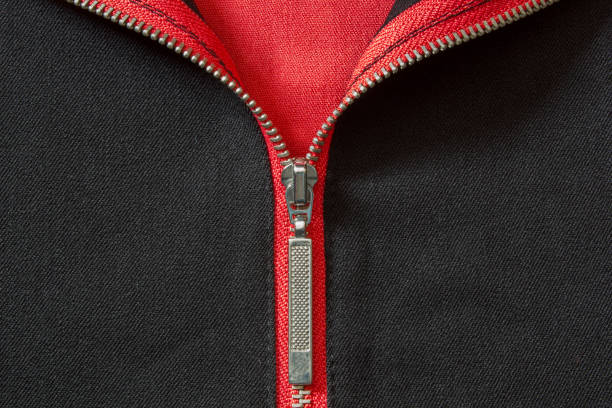 istock Half open silver zip on black and coral color fabric 1491955303