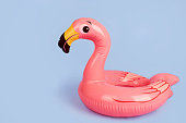 Inflatable flamingo on a blue background, a beach toy.