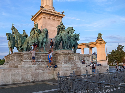 Budapest, Hungary - 15.05.2015: People walking around and climbing on The Memorial to the Fallen Soldiers in Heroes Square
