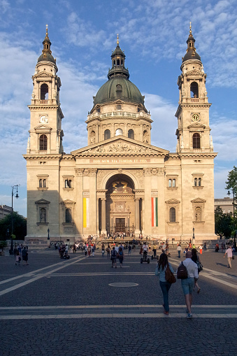 Budapest, Hungary - 15.05.2015: Frontal shot of St. Stephen's Basilica, Roman Catholic basilica in Budapest. Szent Istvan Bazilika in beautiful golden hour light against dark blue sky