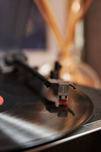 istock black shiny record on a vinyl player. the record player is playing, the head with the needle is lowered onto the record 1491970857