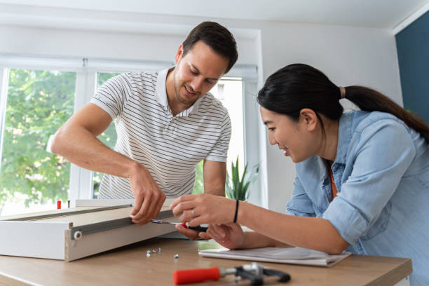 istock Multiracial couple together assembling drawers for kitchen cabinets 1491980119