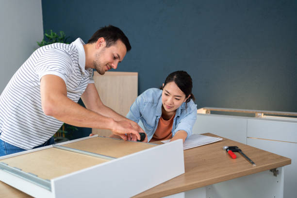 istock Dedicated multiracial couple together assembling drawers for kitchen cabinets 1491980122