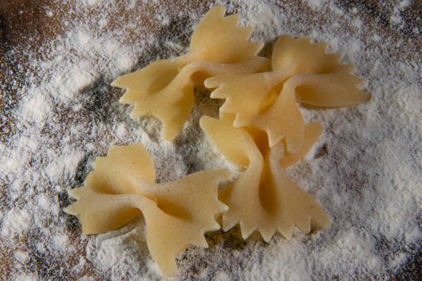 A table sprinkled with flour and pasta in close-up, from above