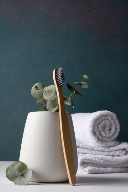 istock Eco-friendly bamboo toothbrushes in a white holder 1491986345