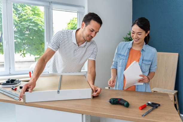 istock Young multiracial couple together assembling drawers for kitchen cabinets 1491986624