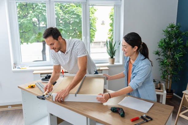 istock Young multiracial couple together assembling drawers for kitchen cabinets 1491986625