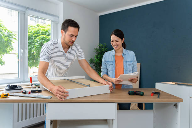 istock Man assembling drawers, while his wife of Japanese ethnicity giving hime instructions 1491986661