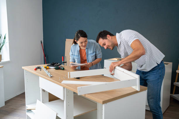 istock Man assembling drawers, while his wife of Japanese ethnicity giving hime instructions 1491986713