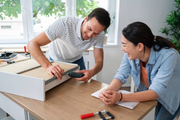 istock Young multiracial couple together assembling drawers for kitchen cabinets 1491986813