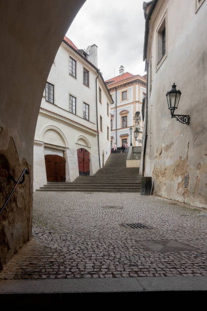 Prague, Czechia - 03.24.2023: People walking in romantic old narrow isles of old city of Prague
