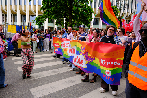 Group of LGBT walking and holding a banner at the Gay Pride Brussels