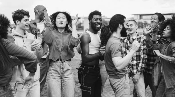 istock Young diverse people having fun outdoor dancing together - Focus on bearded man face - Black and white editing 1491987347
