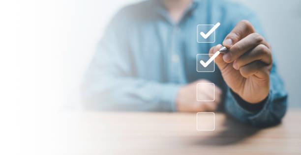 istock Businessman use pen to tick correct sign mark in checkbox for quality document control checklist and business approve project concept. 1491990843