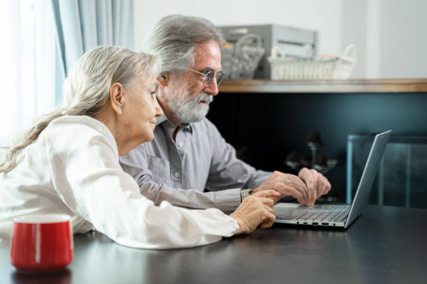 istock Happy family spouses sitting looking at computer screen at living room. 1491995391