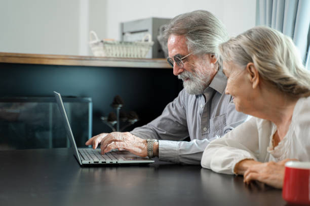 istock Senior couple working and checking personal finances with laptop at home. 1491995397