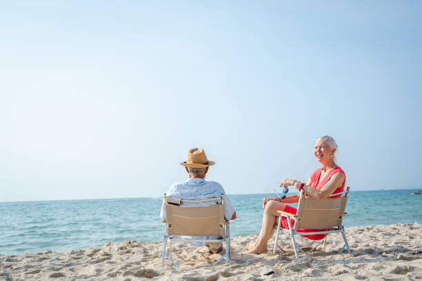 Free Stock Photo of Elderly couple enjoying a moment on a sunny beach ...