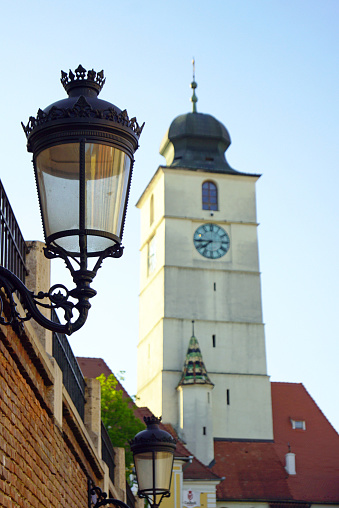 View from an unusual angle on the hallmark of the Romanian city of Sibiu - a clock tower built in the center of the historic district.