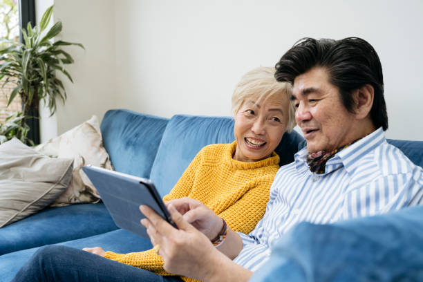istock Senior Chinese couple using digital tablet together at home 1491997014