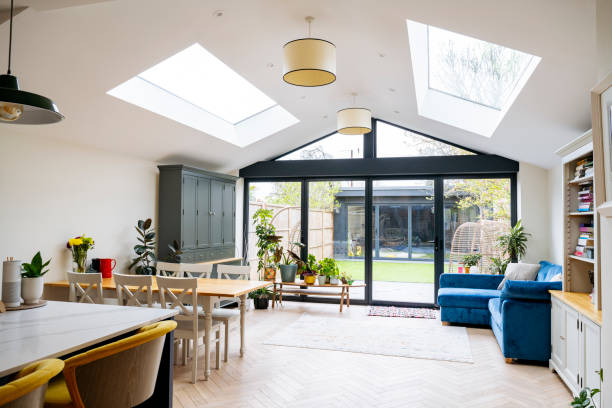 Interior of open plan living space in modern home extension with large patio doors to garden