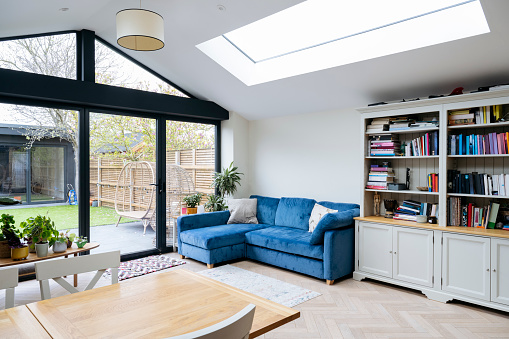 Interior of living area of modern home extension with skylight and large patio doors