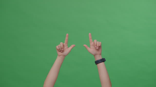 Woman show hands pointing up to copy space.