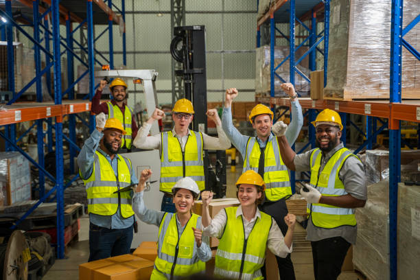 istock Warehouse workers are meeting together,Group of multicultural logistics employees working as a team in in a large distribution warehouse. 1491999335