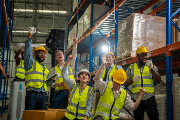 istock Group of multicultural logistics employees working as a team in in a large distribution warehouse. 1491999554