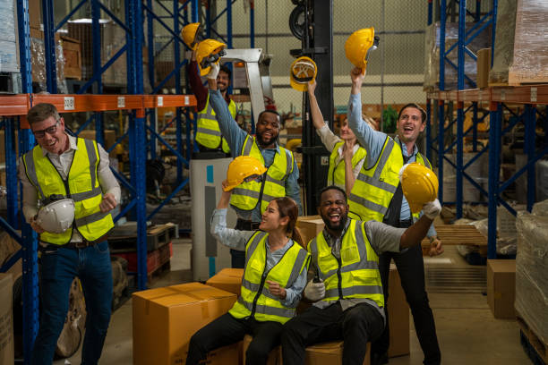 istock Successful warehouse team smiling happily,Cheerful logistics workers in a large distribution warehouse. 1491999557