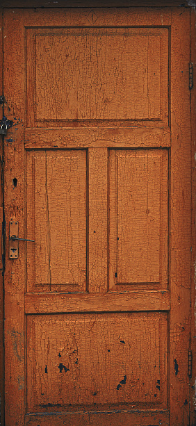 Old shabby brown textured wooden door