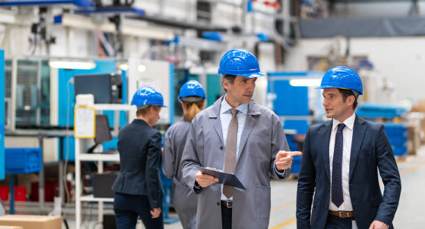 istock Two Engineers Walking Through An Automated Factory And Talking About Working Process 1492015086