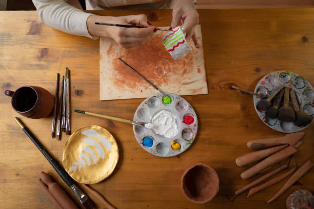 istock Female hands painting a pottery 1492016904