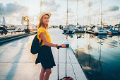 Woman at the marina ready for sailing with yacht