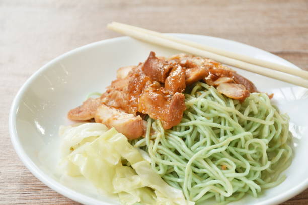 istock jade Chinese egg noodles topping Korean fried slice chicken with cabbage dressing sauce 1492018796