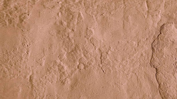istock Stucco plaster wall background texture of brown painted cement, concrete wall 1492019242