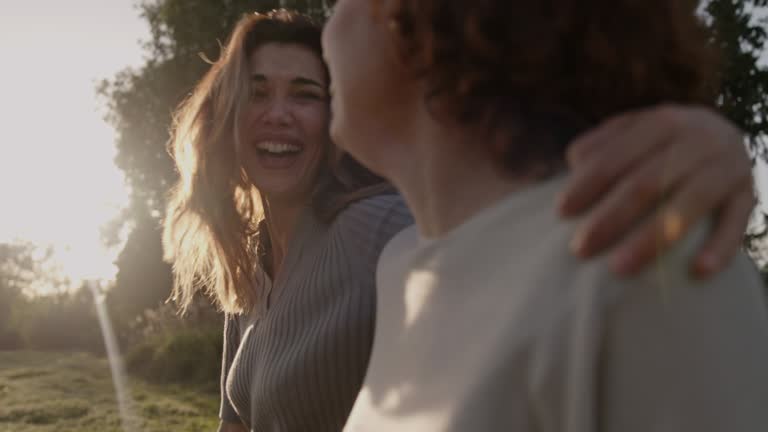 Two women walk in nature talking