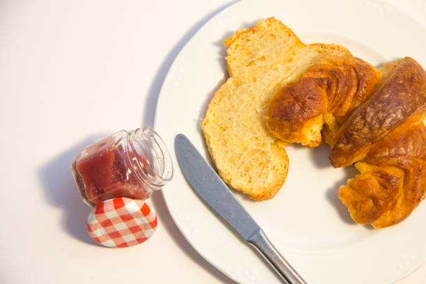 Brioche croissant with jam on white background