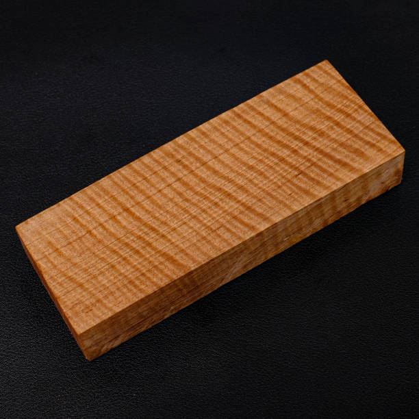 istock Sawn timber of rare maple wood with a beautiful pattern for crafts on black background 1492022028