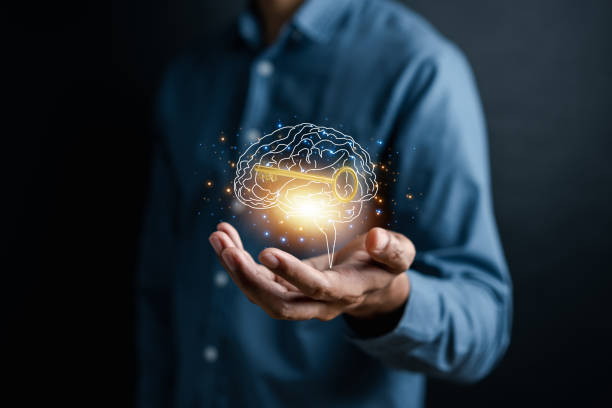 Hand holding virtual human brain and golden key icon, idea creative intelligence to success business goal concept.